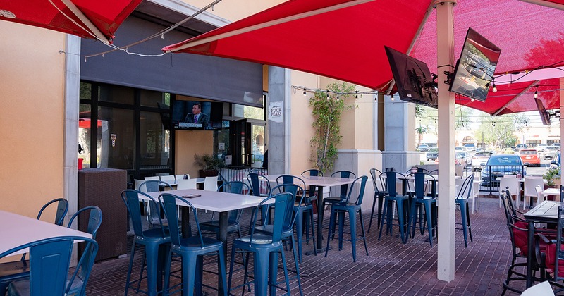 Exterior, patio tables, chairs and red parasols