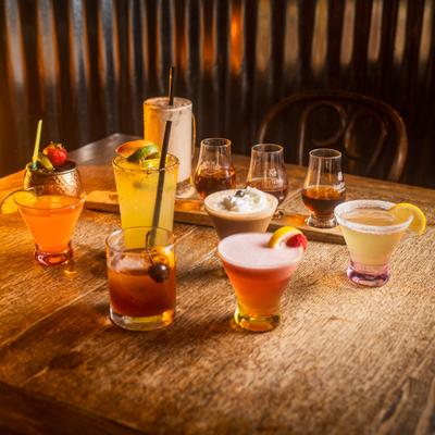 Assorted drinks arranged on a wooden table.