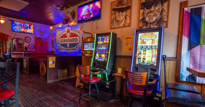 Interior, wide view, game machine, booths, screens above