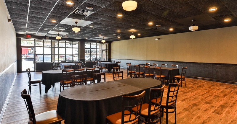 Interior, spacious seating area with large windows behind