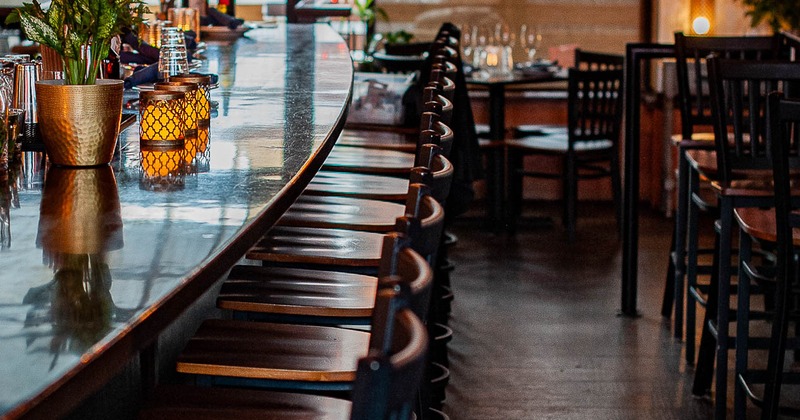 Interior, counter bar and lined-up bar stools