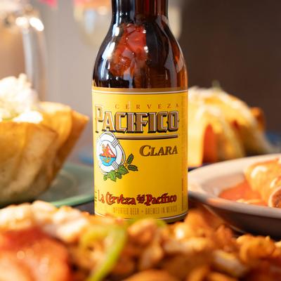 A bottle of Pacifico Clara beer and various meals.