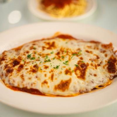 Pollo alla parmigiana with melted cheese and tomato sauce.