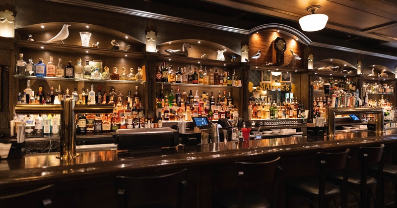 Bar area, bar and drink rack behind