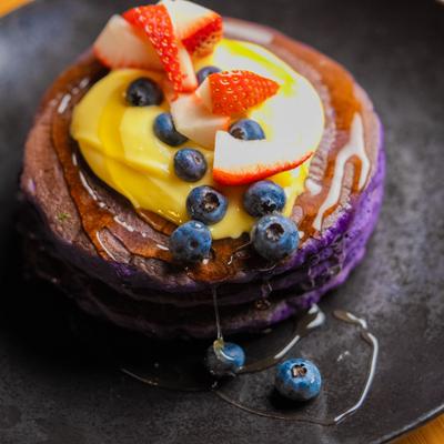 Ube Pancake topped with friut and berries.