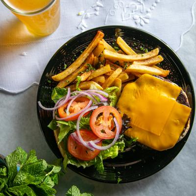 Attiki burger served with fires and a glass of beer.