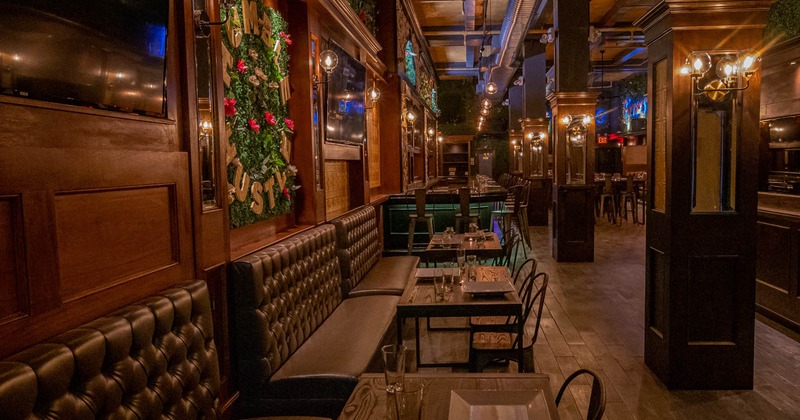 Interior, brown leather banquette benches with tables and chairs, wood covered wall