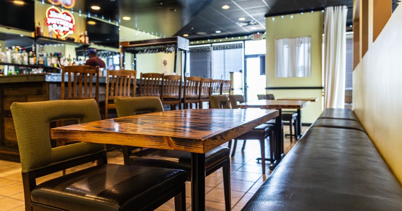Banquette seating with lacquered wooden tables