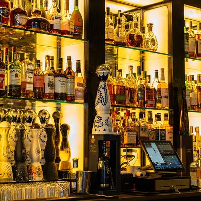 Assorted liquor bottles on the shelf.
