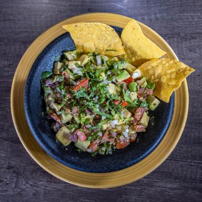 Guacamole with tortilla chips, top view.