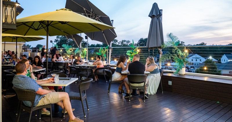 Exterior, terrace, tables, chairs, parasols, sunset atmosphere