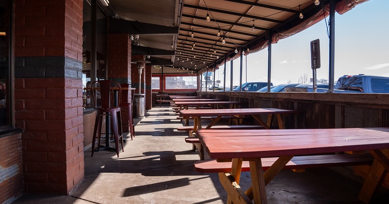 Covered patio with tables and bench seating