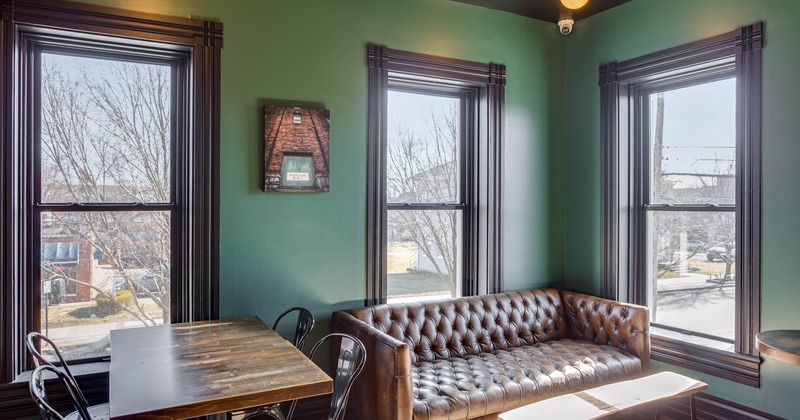 Interior, corner seating, table for four, large vintage leather sofa with coffee table