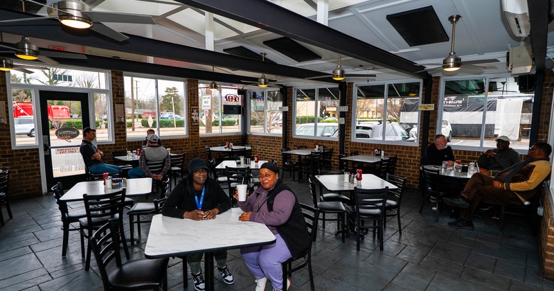 Interior, tables and chairs, guests sitting at the tables