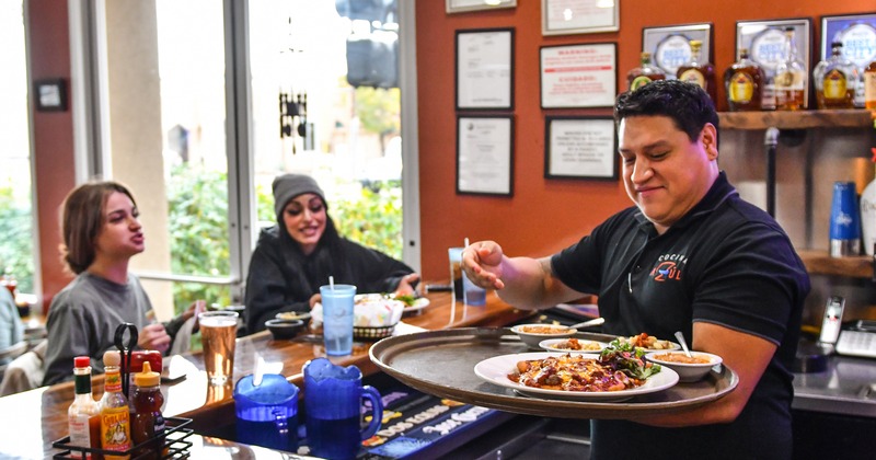 Bar, guests, staff served dishes