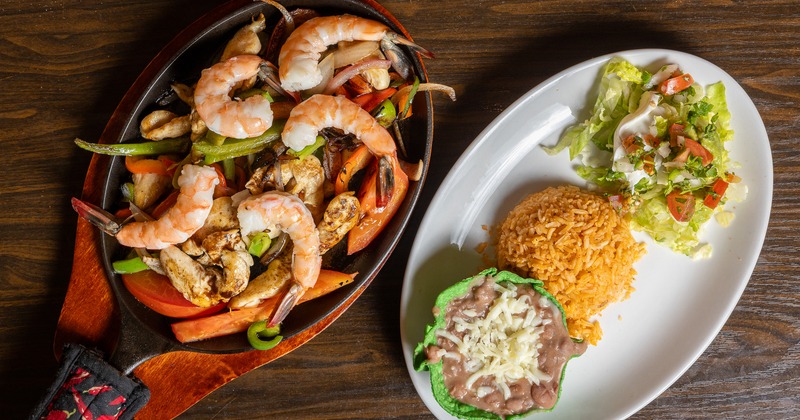 Chicken and  shrimp Fajitas, served with rice, beans, and tomato salsa