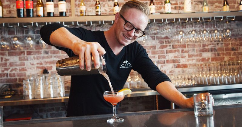Staff member preparing cocktails