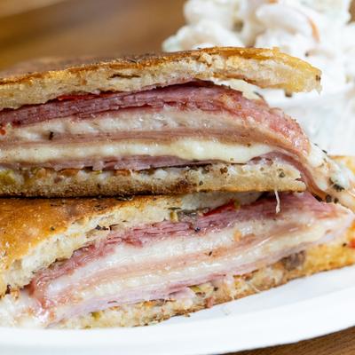 Muffaletta sandwich cut in half, close-up.