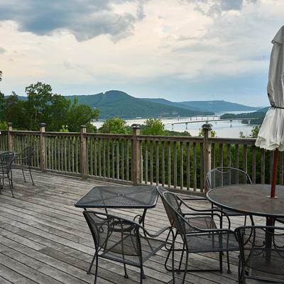 Unroofed porch with a seating area offering a lovely view of the river.