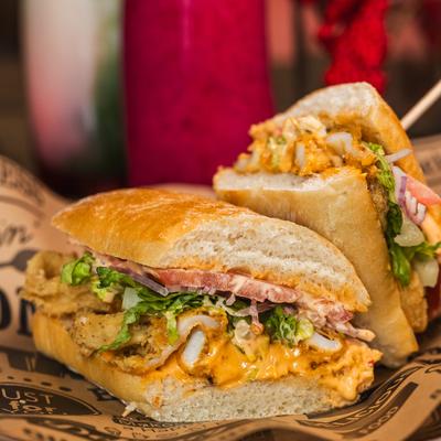 Crispy Calamari Sandwich with lettuce, tomato, onions and aioli.