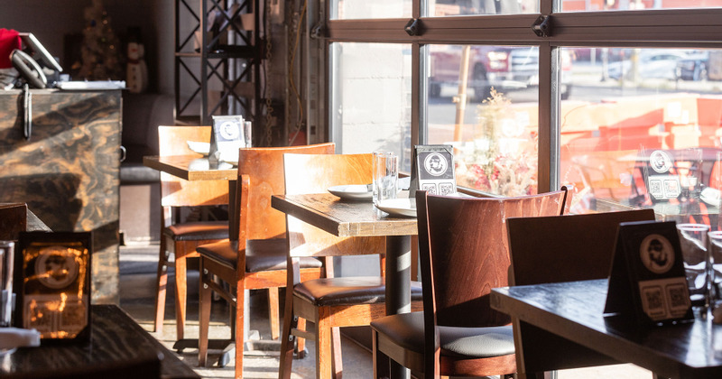 Interior, tables lined up by the window