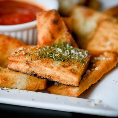Pita Chips With Garlic Parmesan Cheese and a tomato sauce.