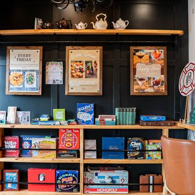Interior, a nook with board game boxes on wall shelves.
