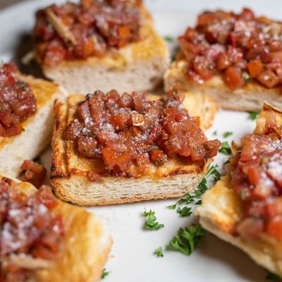 Marinated roma tomatoes, basil and melted cheese on toasted bread.