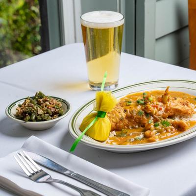 Redfish Atchaflaya served on a bed of steamed rice with Rips Green Beans.