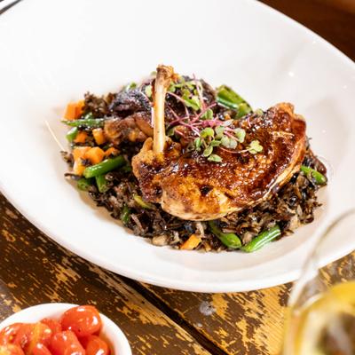 Roasted chicken with vegetables, wild rice and rosemary chicken sauce.