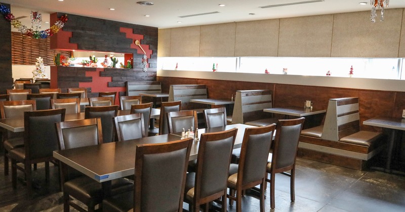 Restaurant interior with tables, chairs, booths, and festive decorations
