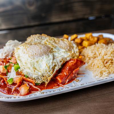 Chorizo Chilaquiles served with Mexican rice and home style potatoes.