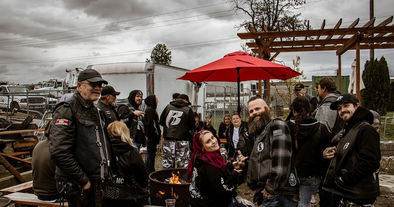 Exterior, bikers have great fun around the fire pit