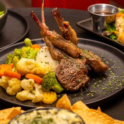 Lamb chops served with mashed potatoes and mix of vegetables.