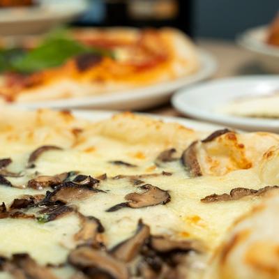 A closeup on pizzas.