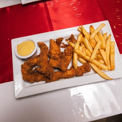 Chicken fingers served with fries and creamy dipping sauce.