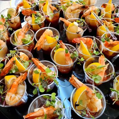 Individual portions of prawn cocktail served in small clear cup.