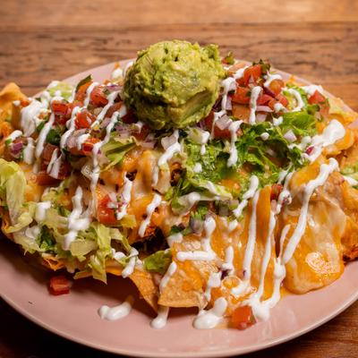Fiesta Nachos with  steak, chorizo, chicken, pico de gallo, sour cream, and guacamole.