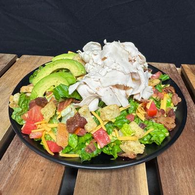 Turkey Club Salad with bacon, avocado, cheddar, tomatoes and crutons.