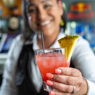 Bartender holding a Margarita cocktail.