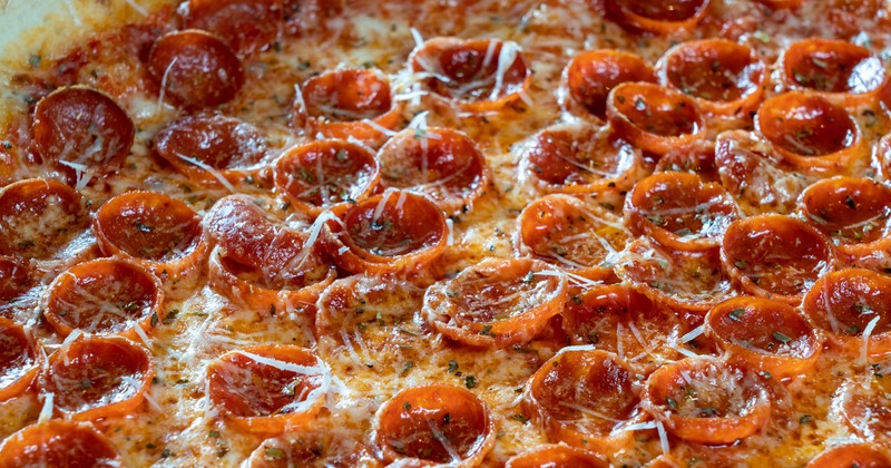 Close up of pepperonis on a pizza.