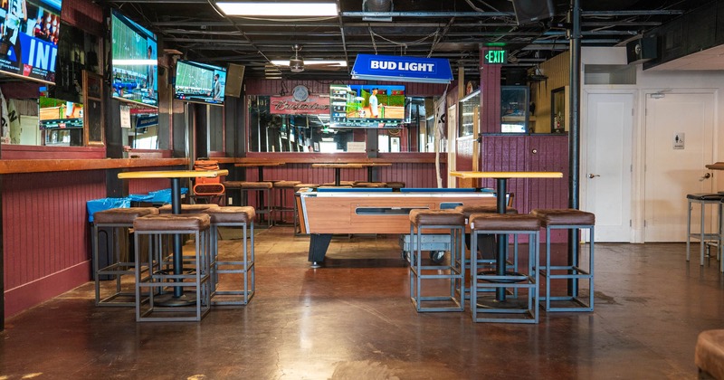 Interior, high tables and chairs around the pool table