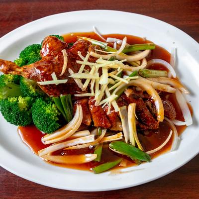 Crispy half duck topped with ginger sauce, served with steamed broccoli and onion.