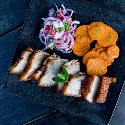 Fried pork, served with red onion salad and sweet potato chips