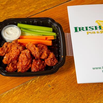 Container with fried chicken, veggie sticks and dip