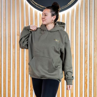 Woman in an olive green ''Hula Pot'' hoodie, front view, closeup.