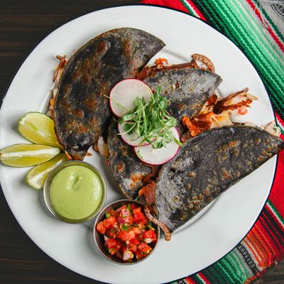 Sinaloa Shrimp Tacos, served with pico de gallo, habanero chili, and avocado crema.