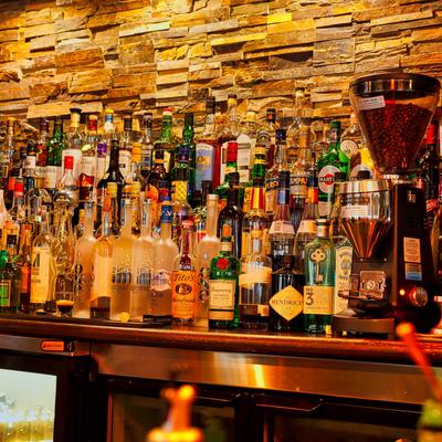 Liquor bottles arranged on a bar shelf.