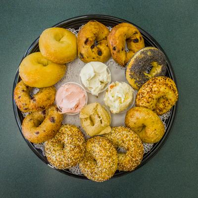 Assorted bagels with spreads, top view.