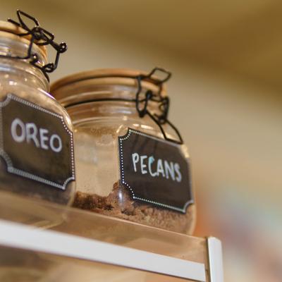 Glass jars featuring metal swing-top lids and rustic chalkboard label.